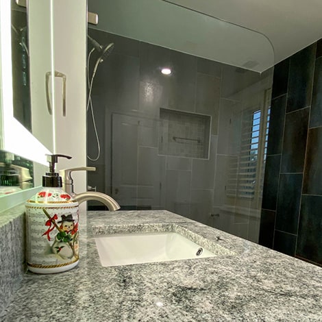 Decorative shower and bath remodel using marble countertops